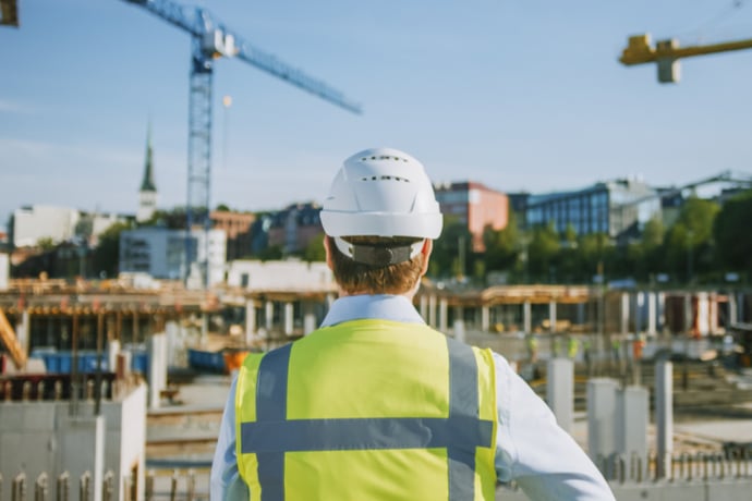 Construction professional overlooking a building site